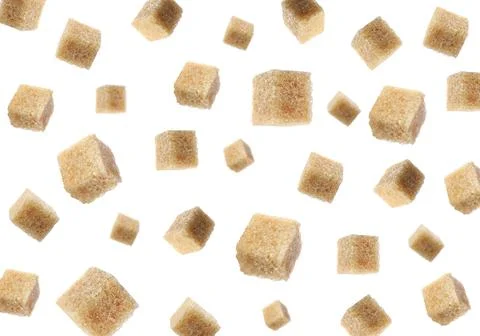 Flying cubes of brown sugar on white background Stock Photos