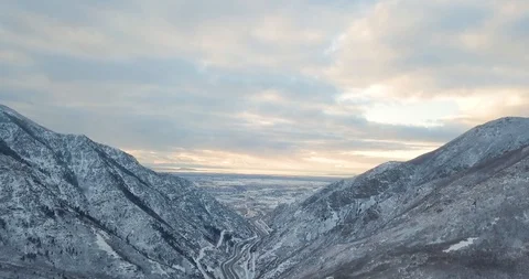 Flying DJI Mavic Pro through Ogden, Utah winter canyons along side traffic. Video stock 106433917