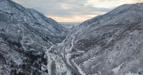 Flying DJI Mavic Pro through Ogden, Utah winter canyons along side traffic. Stock Footage 106433960