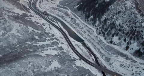 Flying DJI Mavic Pro through Ogden, Utah winter canyons along side traffic. Stock Footage 106434289