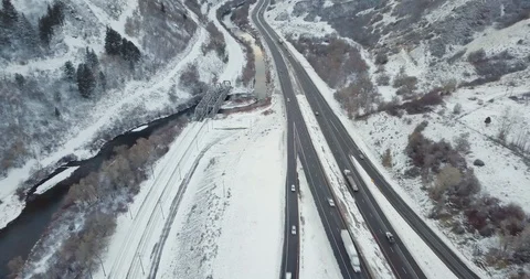 Flying DJI Mavic Pro through Ogden, Utah winter canyons along side traffic. Stock Footage 106434303
