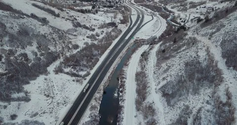 Flying DJI Mavic Pro through Ogden, Utah winter canyons along side traffic. Stock Footage 106434386