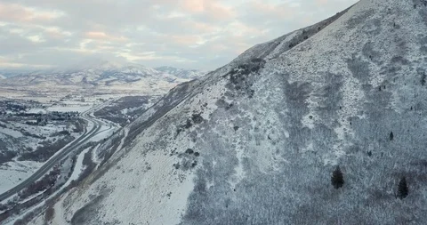 Flying DJI Mavic Pro through Ogden, Utah winter canyons along side traffic. Stock Footage 106464180