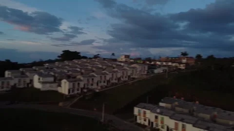 Flying with a dji mini 2 drone through a sports field until arriving at a town Stock Footage 235705065