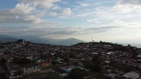 Flying with a dji mini 2 drone through a sports field until arriving at a town Stock Footage 235944225