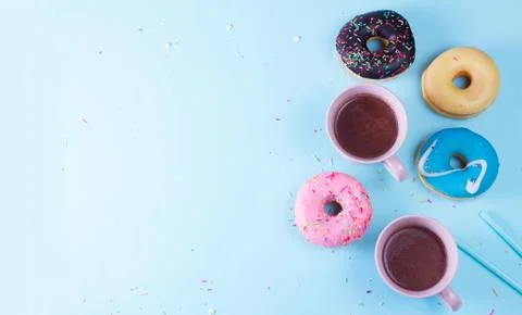 Flying doughnuts on blue Stock Photos