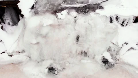 Flying Down &amp; Away from a Partially Frozen Waterfall in Winter Stock Footage 103377555