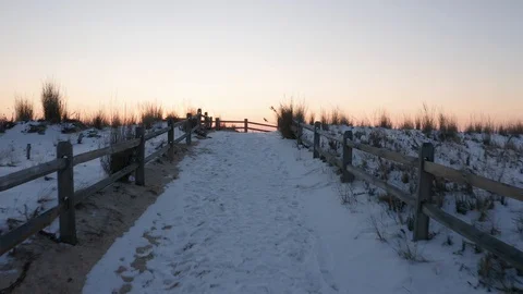 Flying down a beach path towards the ocean at sunrise Stock Footage 105550454