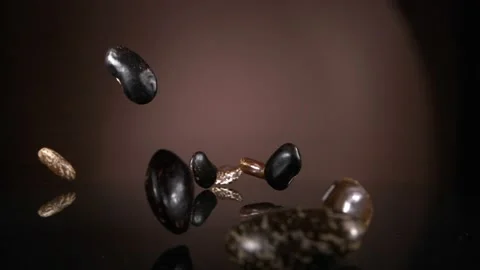 Flying down the beans on a brown background. Super slow-motion. Видео 149924513