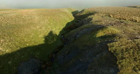 Flying down misty hill Stock Footage 312358933