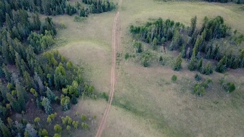 Flying down mountain path towards campers 스톡 동영상 87622041