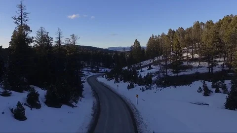 Flying down mountain road covered in snow Stock Footage 73049632