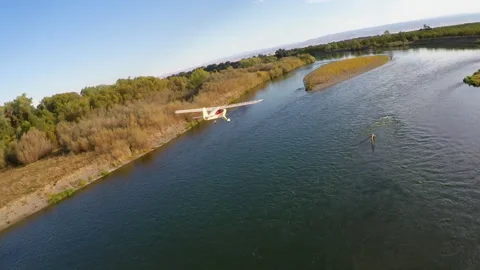 Flying down river light plane over water Vídeo Stock 240120820
