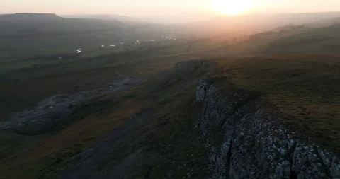 Flying down rocky ridge at sunset Stock Footage 307260483