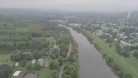 Flying down a rural river with city Video stock 122015766