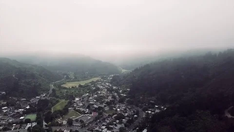 Flying Down Through Clouds To Reveal Town Below Video stock 83143087