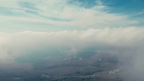 Flying down through moving clouds Stock Footage 274312920