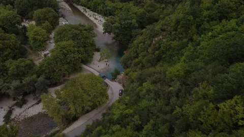 Flying down towards blue mountain river in  forest Stock Footage 220383452