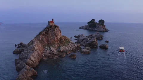 Flying drone 4K video around Sveta Nedjelja Island with magestic small church on Video stock 296553384
