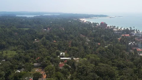 Flying on a drone above the beach and the ocean with waves at dawn. Sunny weathe Stock Footage 104855979