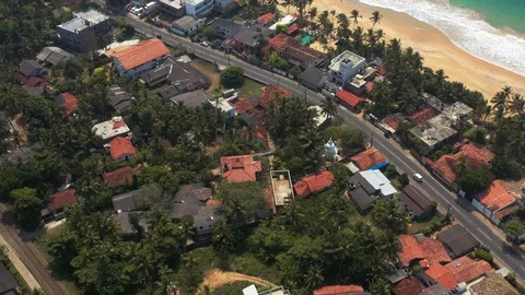 Flying on a drone above the beach and the ocean with waves at dawn. Sunny weathe Stock Footage 104856005