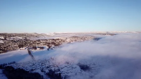 Flying drone above clouds and hills towards Drammen, Norway Stock Footage 85819653