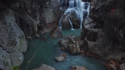 Flying on the drone above the wild waterfall in tropical palm forest. Beautiful 動画素材 112655908