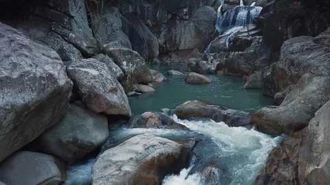 Flying on the drone above the wild waterfall in tropical palm forest. Beautiful 動画素材 112656094