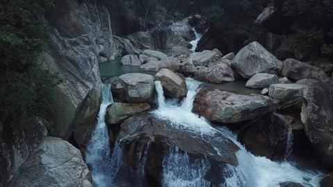 Flying on the drone above the wild waterfall in tropical palm forest. Beautiful 動画素材 112656164