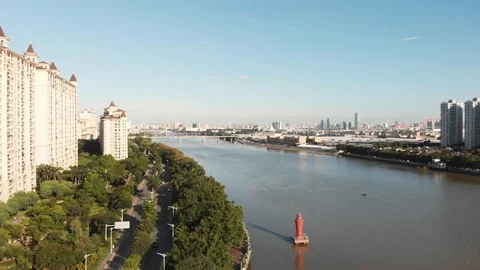 Flying drone along the promenade. In the frame of a new building, a river. Stock Footage 113336328