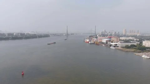 Flying drone along the river. In the frame, cargo barges, a small port. Stock Footage 117997607
