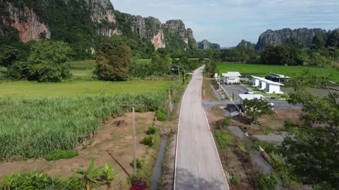 Flying a drone along the road with limestone mountains in the background. Stock Footage 304498478