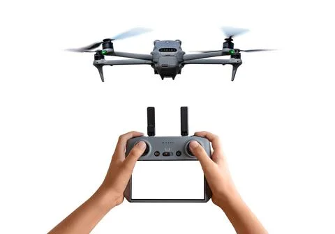 Flying drone and handheld controller on white background, presenting modern.. Stock Photos