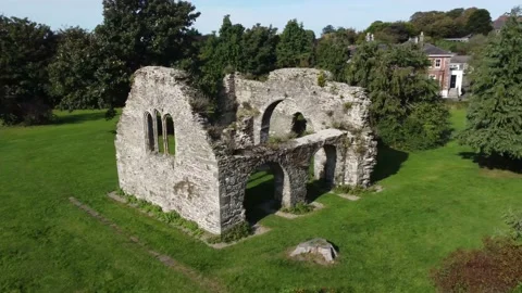 Flying drone around The Abbey Grounds ruins Wicklow, Ireland. Orbit aerial shot Stock Footage 168199460