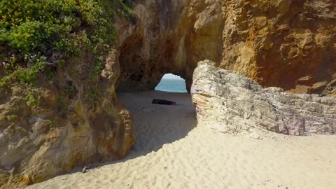 Flying Drone On the Beach through a hole leading to the ocean Video stock 244941582