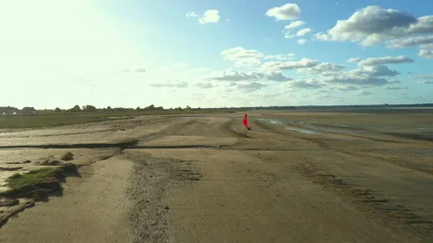 Flying a drone behind Blokarts along the shore Stock Footage 152942452