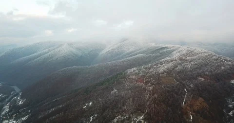 Flying drone between the snowy mountain peaks of the river winter snow 4k Stockbeeldmateriaal 123610646
