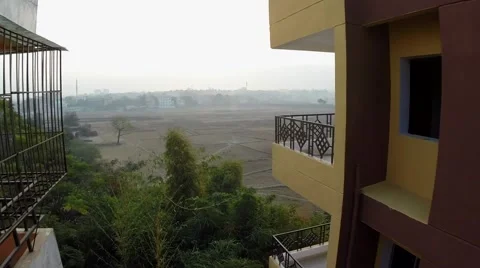 Flying drone between two buildings to reveal country side Stock Footage 65793512