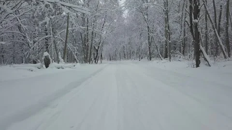 Flying drone camera on a snowy forest road in snowy weather Vídeo Stock 146461890