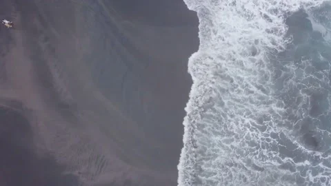 Flying drone captures the dark coast and blue sea waves. Stock Footage 155973097