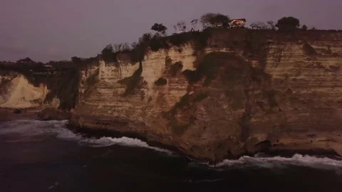 A flying drone captures the relief of a mountain and sea edge in Indonesia. Stock Footage 155998708