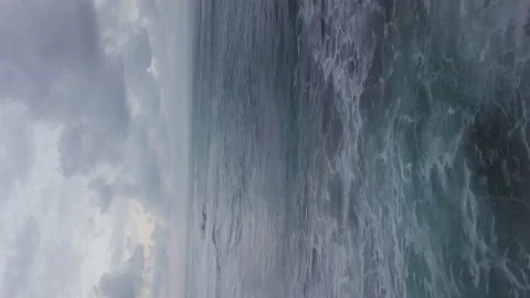 A flying drone captures the waves of the blue sea of Indonesia. (vertical video) Stock Footage 155972497