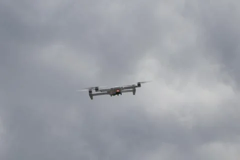 Flying drone with clouds background Stock Photos