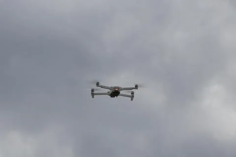 Flying drone with clouds background Stock Photos