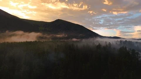 Flying a drone in the clouds over the Multinsky mountain lake in Altai Stock Photos