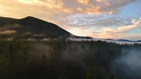 Flying a drone in the clouds over the Multinsky mountain lake in Altai Stock Photos