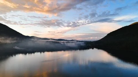 Flying a drone in the clouds over the Multinsky mountain lake in Altai Stock Photos