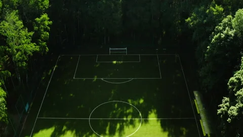 Flying drone dolly view of hidden football field Stock Footage 197281222