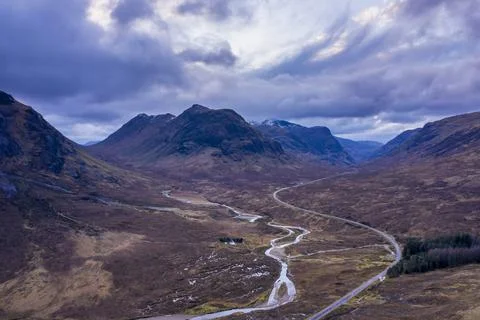 Flying drone epic landscape image of mountains rivers and valleys in Glencoe  Stock Photos