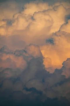 Flying drone in fluffy clouds in the sunlight. Stock Photos
